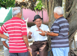 3 old men chatting in downtown Puerto Armuelles, Panama