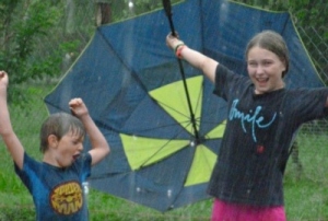 Two children celebrating in the rain