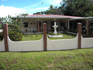 Concrete house and yard with outdoor fountain