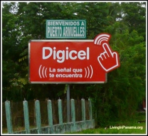 Welcome to Puerto Armuelles sign on top of bigger red Digicel sign
