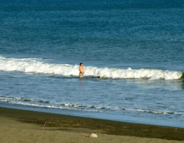 Photo of middle aged man standing in the surf