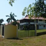 Yellow cement fence, Side view of house and yard