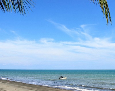 Photo of fishing boat in ocean and blue sky