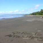 Photo of beach with writing in the sand