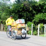 Photo of man with a cargo bike filled with boxes