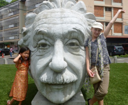 Big Statue of Albert Einstein's head with two young girls posing - in Panama City