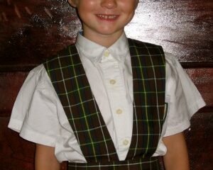 Smiling young girl in plaid 7th Day Adventist school uniform