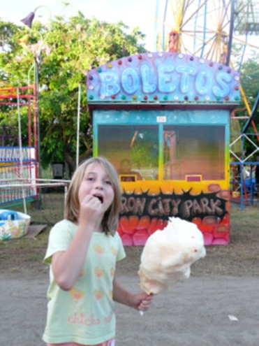 Girl eating cotton candy at the fair