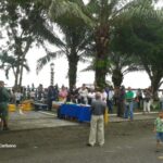 people listening to speech at waterfront park in puerto armuelles panama