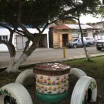 stoold make of tires, painted white, around a table also made of tires