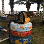 Colorful bird and stand made of tires and paint