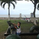 Boy playing on new car built of recycled tires