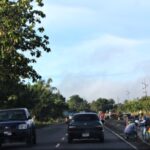 Traffic flows as men work on the road