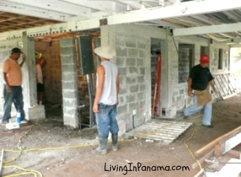 3 workers at a cement block house construction site