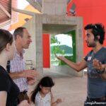 Museum staff person giving information to a family