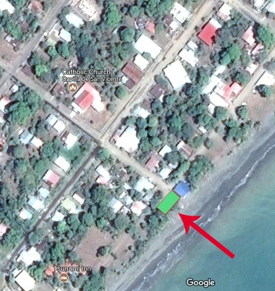 Screenshot of google map satellite view with lot marked in green, with red arrow