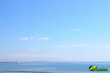 Big blue sky & ocean, with a sailboat in the distance