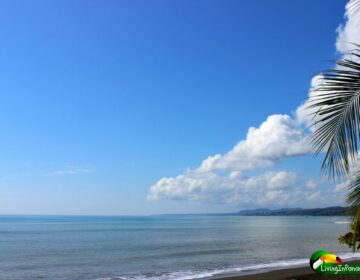 peaceful flat ocean, blue sky, puffy white clouds