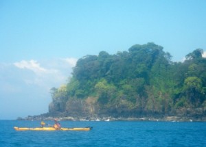paddler in yellow kayak enjoying the blue water and sky near Boca Chica