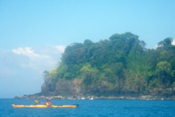 paddler in yellow kayak enjoying the blue water and sky near Boca Chica