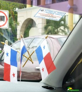 3 small Panama flags attached to windshield of a taxi