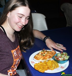 Girl showing off dinner at seafood resturant in Puerto Armuelles Panama