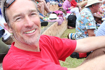 Middle-aged man sitting with other in an amphitheatre in Boquete Panama