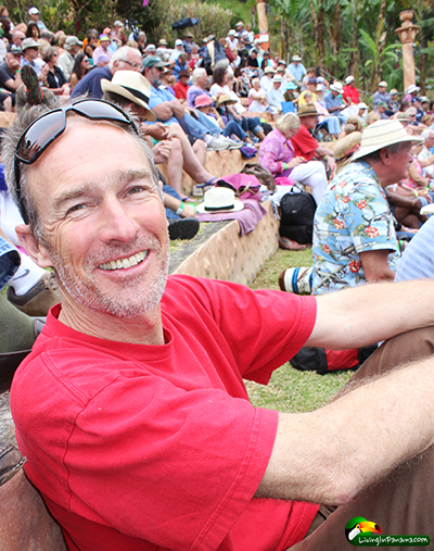 Middle-aged man sitting with other in an amphitheatre in Boquete Panama