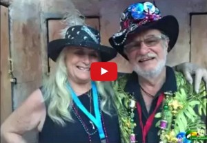 screenshot of video with photo of older couple with fun hats