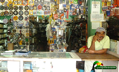Man on phone behind counter of hardware store in Panama