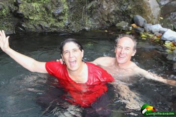 couple submerged, except heads, in a pool of water -