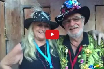 screenshot of video with photo of older couple with fun hats