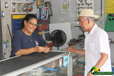 women behind counter helping a customer