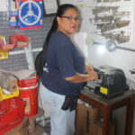 Woman cutting a key in a hardware store in Puerto Armuelles Panama