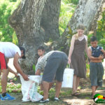 Kids and adults gathering mangos on Easter