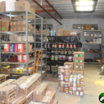 shelves full of various boxes, paint, and building supplies