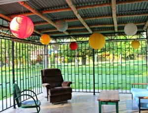 living room with furniture and colorful balls handing off bamboo roof