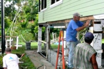 3 men remodeling a wooden house in Panama