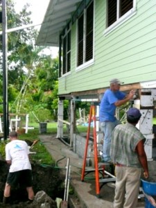 3 men working on exterior of house
