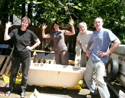 2 women and 2 men getting ready to move a clawfoot tub