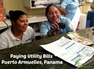 2 smiling women scanning utilities bills and accepting payment