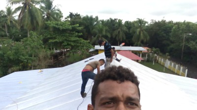 men working on a metal roof