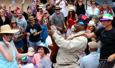 Blues guitarist going through outdoor crowd