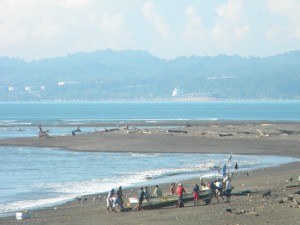 fishermen launching a boat from shore