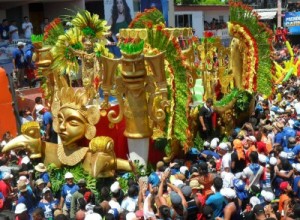 egyptian looking float surrounded by a crowd of peoplw