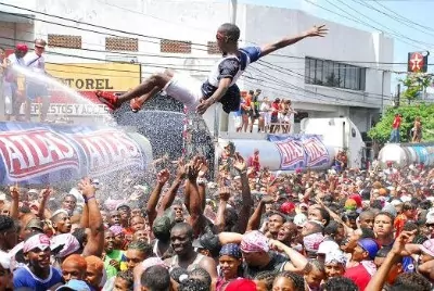 man thrown up in the air by a crowd of people