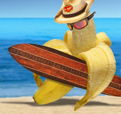 half peeled banana with straw cowboy hat and surfborad