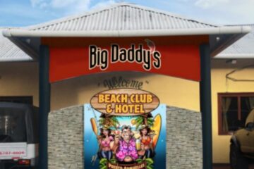 Photo of front of Big Daddy's Beach Club & Hotel - with its logo of fat middle aged man flanked by 2 young bikini clad girls