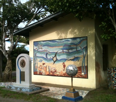photo of building with mosaic mural and statues