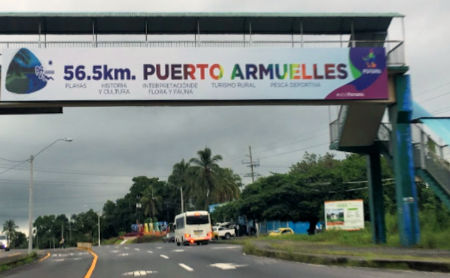 Banner about Puerto Armuelles hung from freeway pedestrian overpass.